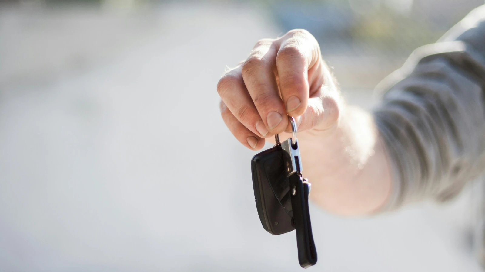 Car rental handover process in Kraków showing keys and documents